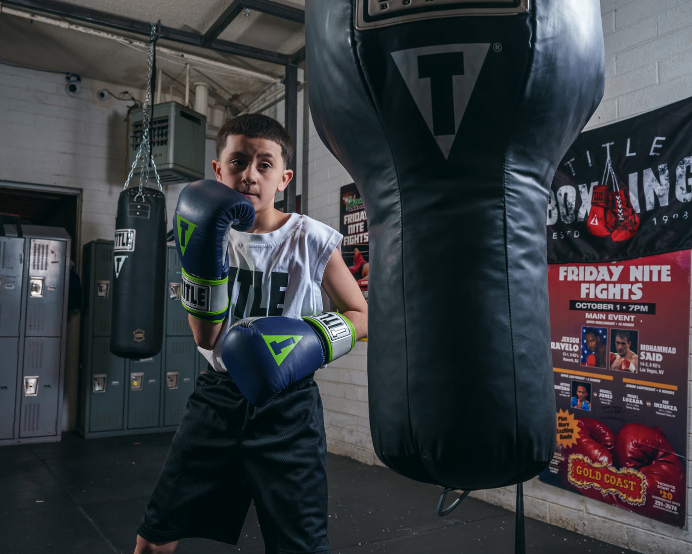variant:navy/grey::TITLE Boxing Gel World V2T Bag Gloves  kid boxing stance with bag