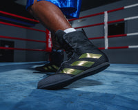 variant:black/gold::Adidas Box Hog 4 Boxing Boots feet on ring