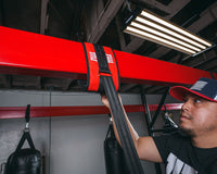 variant:lifestyle::TITLE Boxing Universal Heavy Bag Hanger being tightened by a boxer