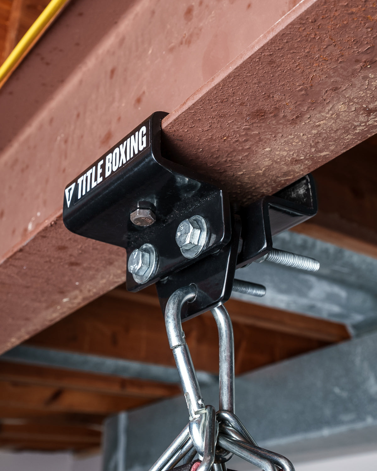 variant:lifestyle::TITLE Boxing I-Beam Heavy Bag Hanger in use in a boxing gym