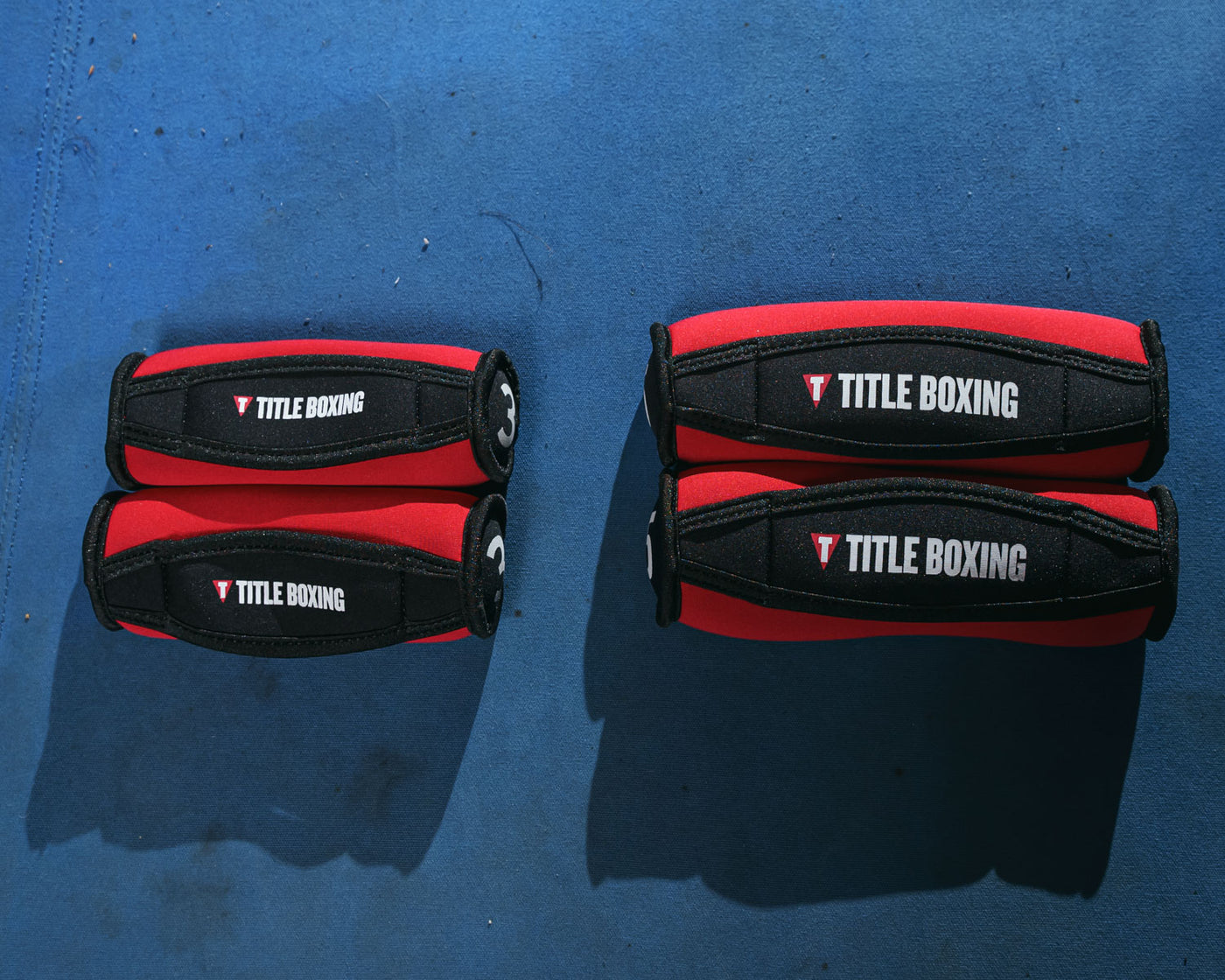 variant:lifestyle::TITLE Boxing Heavy-Hitter Hand Weights 2.0 showing the title logo