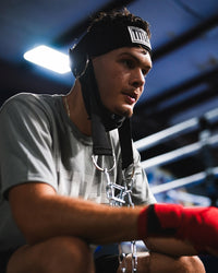 variant:lifestyle::TITLE Boxing Nylon Head Harness 2.0 on fighter closeup of headstrap with head up