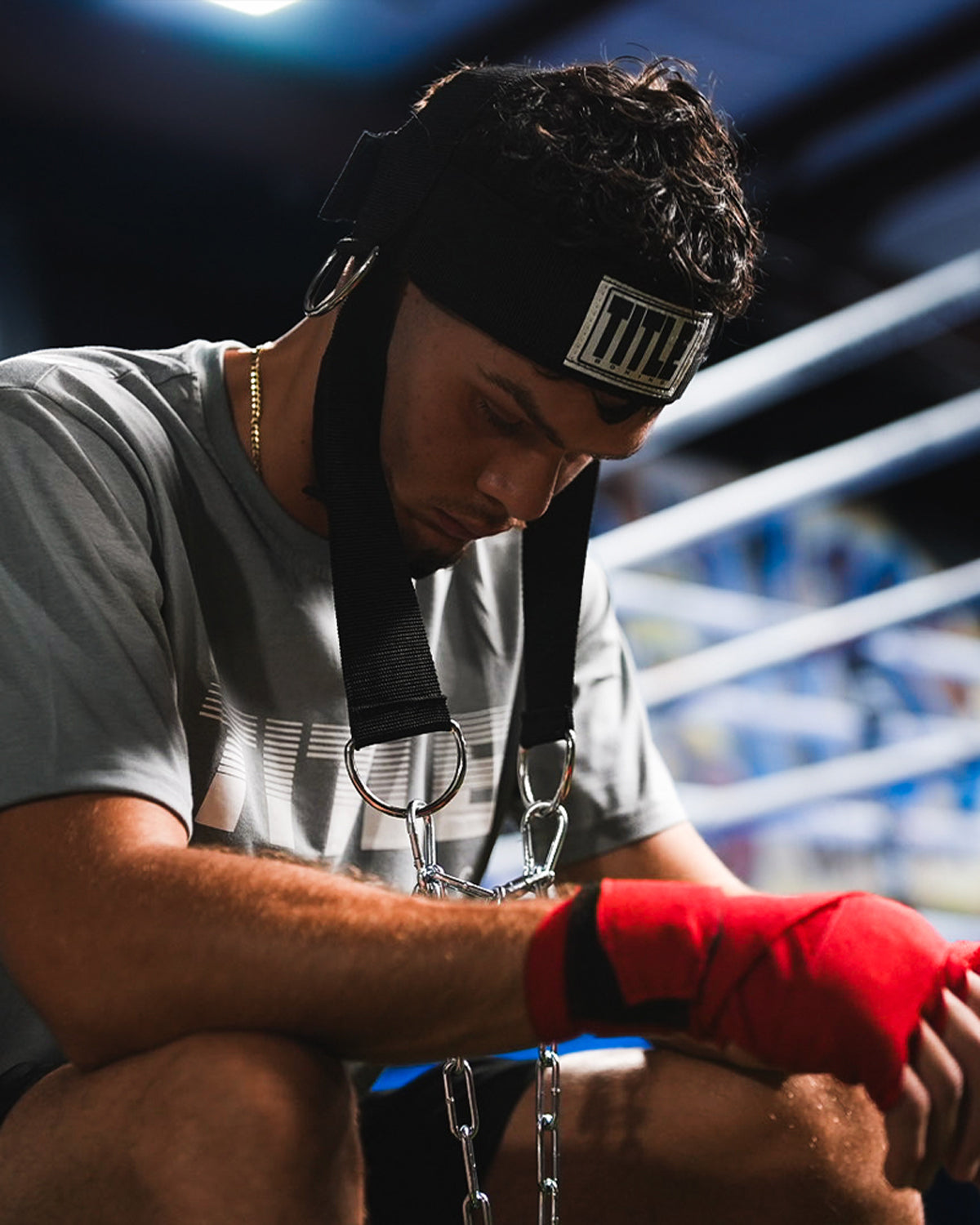 variant:lifestyle::TITLE Boxing Nylon Head Harness 2.0 on fighter closeup of headstrap with head down