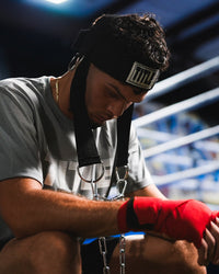 variant:lifestyle::TITLE Boxing Nylon Head Harness 2.0 on fighter closeup of headstrap with head down