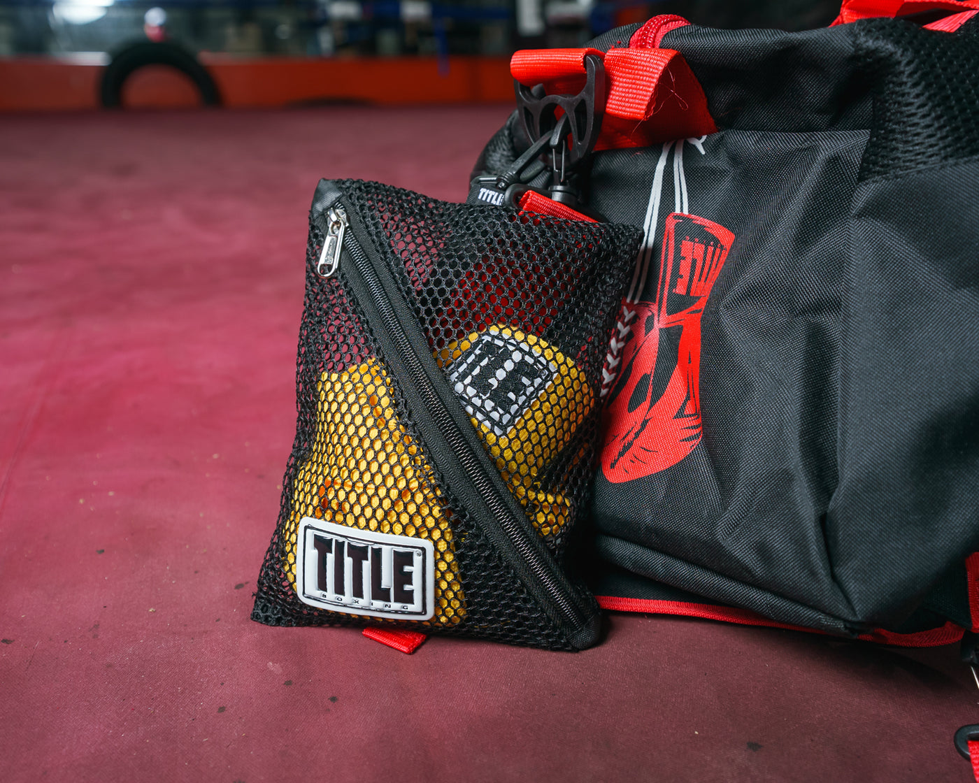variant:S::TITLE Boxing Clip On Mesh Hand Wrap Bag attached to gym bag