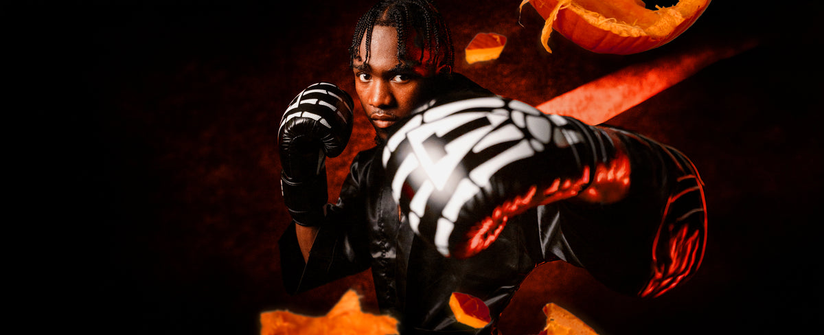 boxer wearing skeleton hand bag gloves