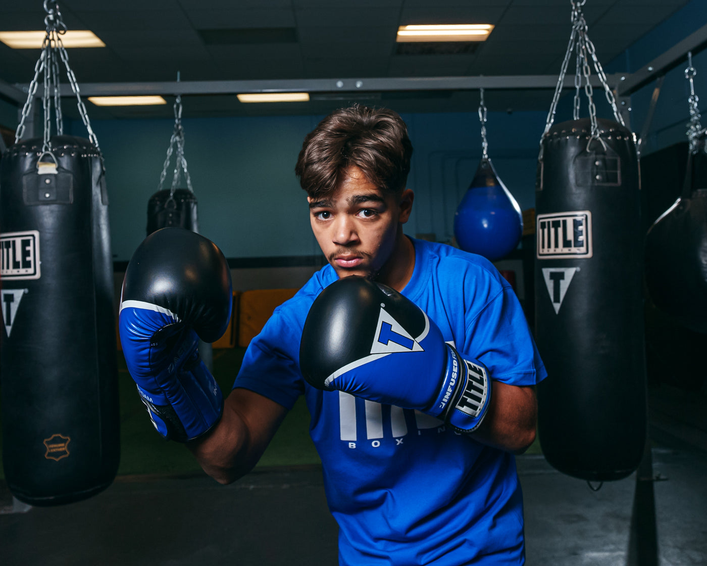 variant:blue/black::TITLE Boxing Infused Foam Interrogate Training Gloves 2.0 boxing pose