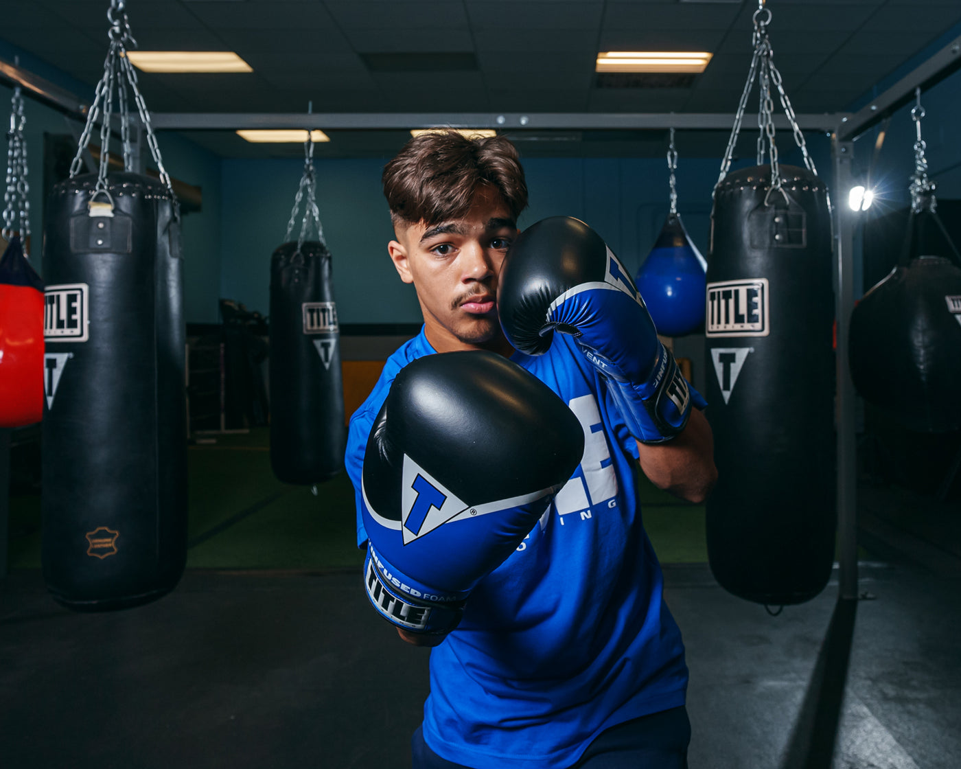 variant:blue/black::TITLE Boxing Infused Foam Interrogate Training Gloves 2.0 boxing stance