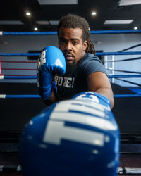 variant:Blue/White::TITLE Boxing Inferno Intensity Lace Training Gloves guy throwing left jab