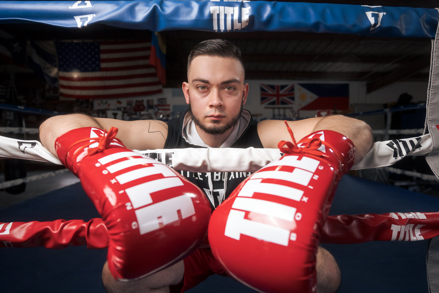 variant:Red/White::TITLE Boxing Inferno Intensity Lace Training Gloves guy on ring ropes