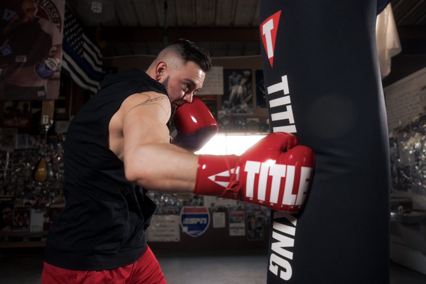 variant:Red/White::TITLE Boxing Inferno Intensity Lace Training Gloves guy hitting bag