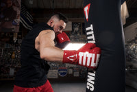 variant:Red/White::TITLE Boxing Inferno Intensity Lace Training Gloves guy hitting bag