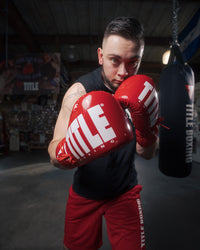 variant:Red/White::TITLE Boxing Inferno Intensity Lace Training Gloves guy boxing stance