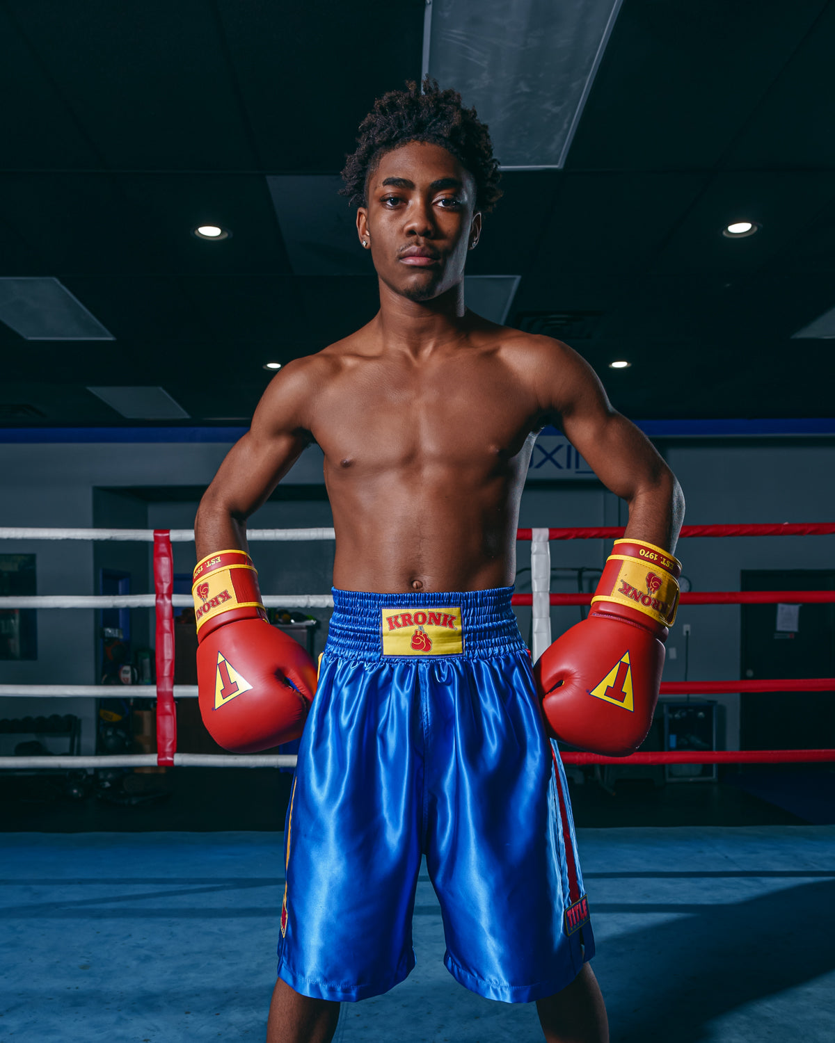 variant:blue::KRONK Boxing Gym Trunks standing in ring