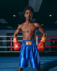 variant:blue::KRONK Boxing Gym Trunks standing in ring