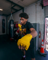variant:gold::KRONK Boxing Gym Hand Wraps kid boxing stance