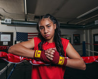 variant:red::KRONK Boxing Gym Hand Wraps girl putting on wraps girl hands together