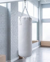 variant:white::TITLE Boxing KO-Vert Heavy Bag hanging in the gym