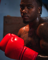 variant:red::TITLE Boxing Ko-Vert Training Boxing Gloves on boxer in fighting stance