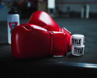 variant:red::TITLE Boxing Ko-Vert Training Boxing Gloves on side of boxing ring
