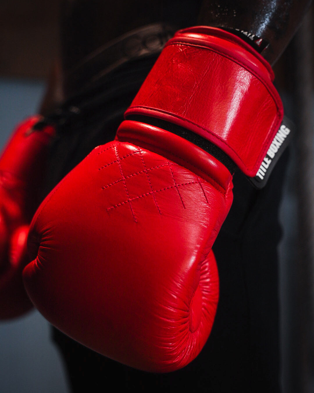 variant:red::TITLE Boxing Ko-Vert Training Boxing Gloves on boxer's hand closeup