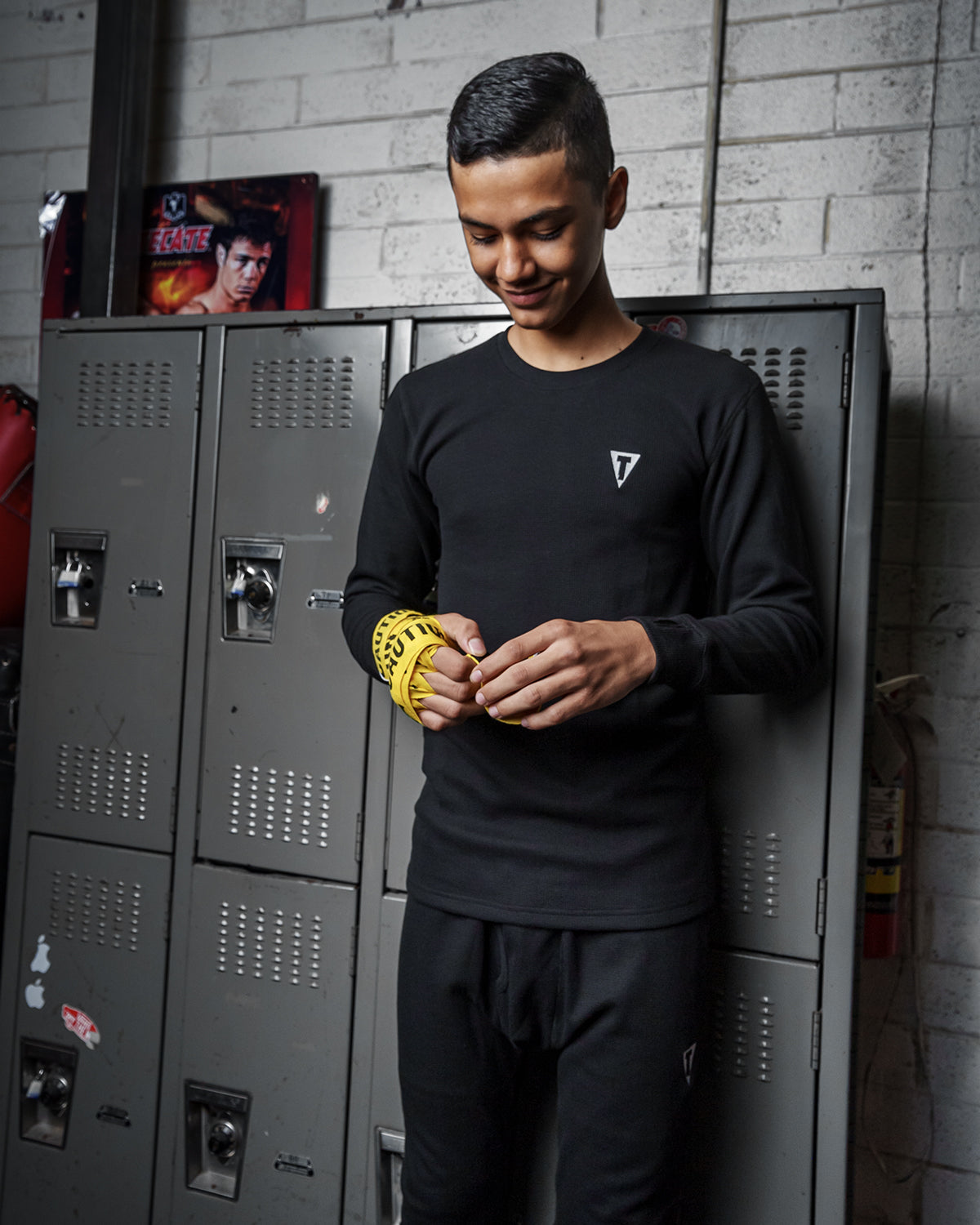 variant:black::TITLE Boxing Thermal Wear Long Sleeve man in front of lockers