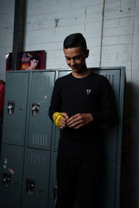 variant:black::TITLE Boxing Thermal Wear Pants infront of lockers