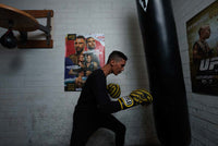 variant:black::TITLE Boxing Thermal Wear Pants kid hitting bag