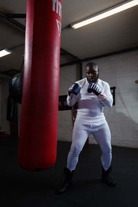 variant:white::TITLE Boxing Thermal Wear Pants guy hitting bag