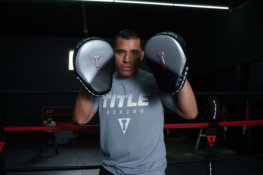 variant:grey::TITLE Boxing Streaked Print Tee coach in gym with mitts