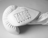 variant:white::TITLE Boxing Momentum Pro Bag Gloves closeup of logo on thumb