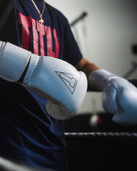 variant:white::TITLE Boxing Momentum Pro Bag Gloves on boxer's hands in the ring