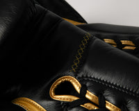 variant:black/gold::TITLE Boxing Momentum Pro Sparring Gloves closeup of laces