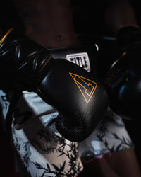variant:black/gold::TITLE Boxing Momentum Pro Sparring Gloves closeup on boxer's hands