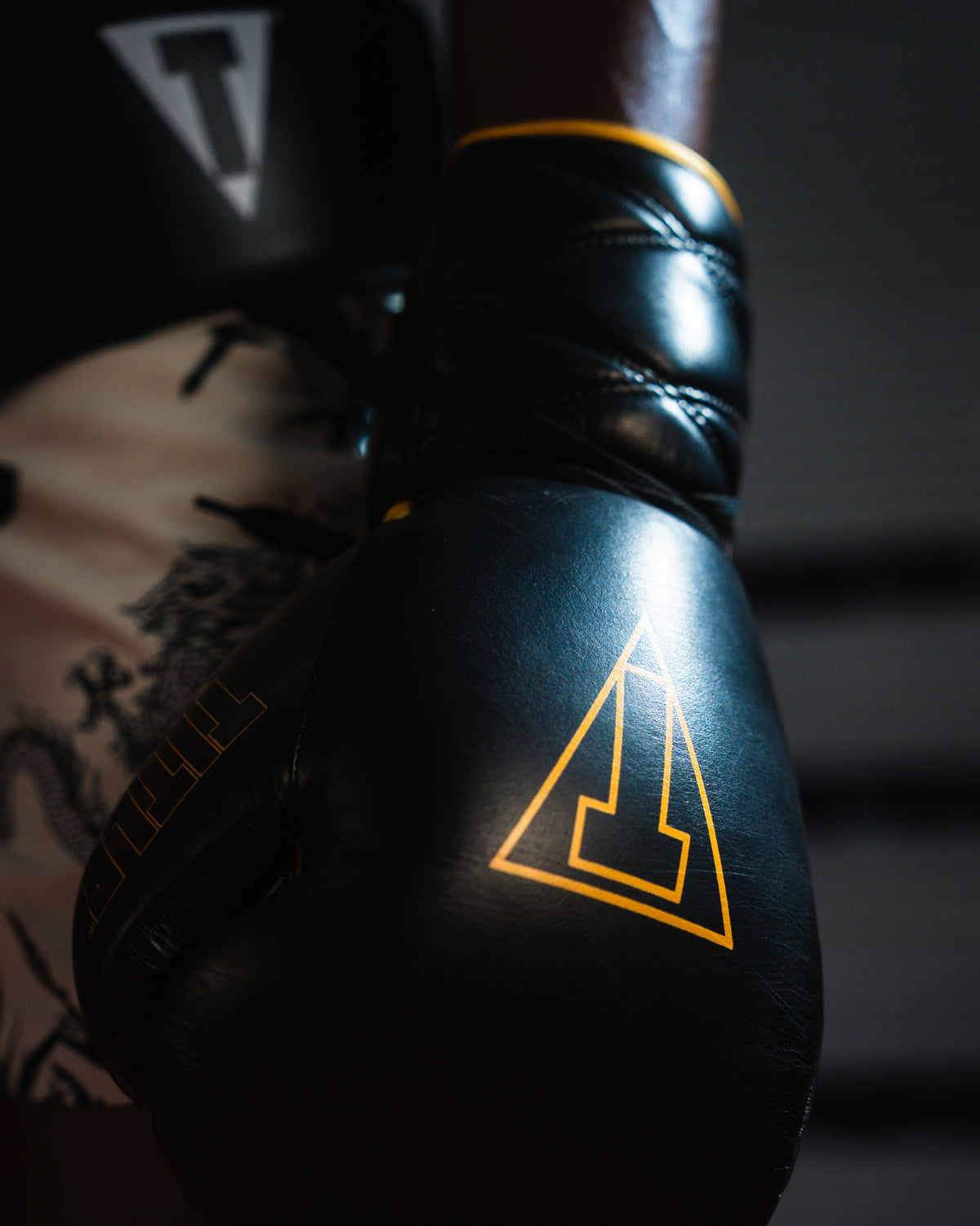 variant:black/gold::TITLE Boxing Momentum Pro Sparring Gloves closeup on boxer's hand