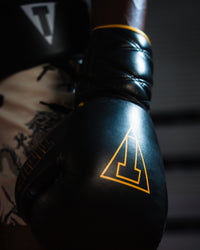 variant:black/gold::TITLE Boxing Momentum Pro Sparring Gloves closeup on boxer's hand