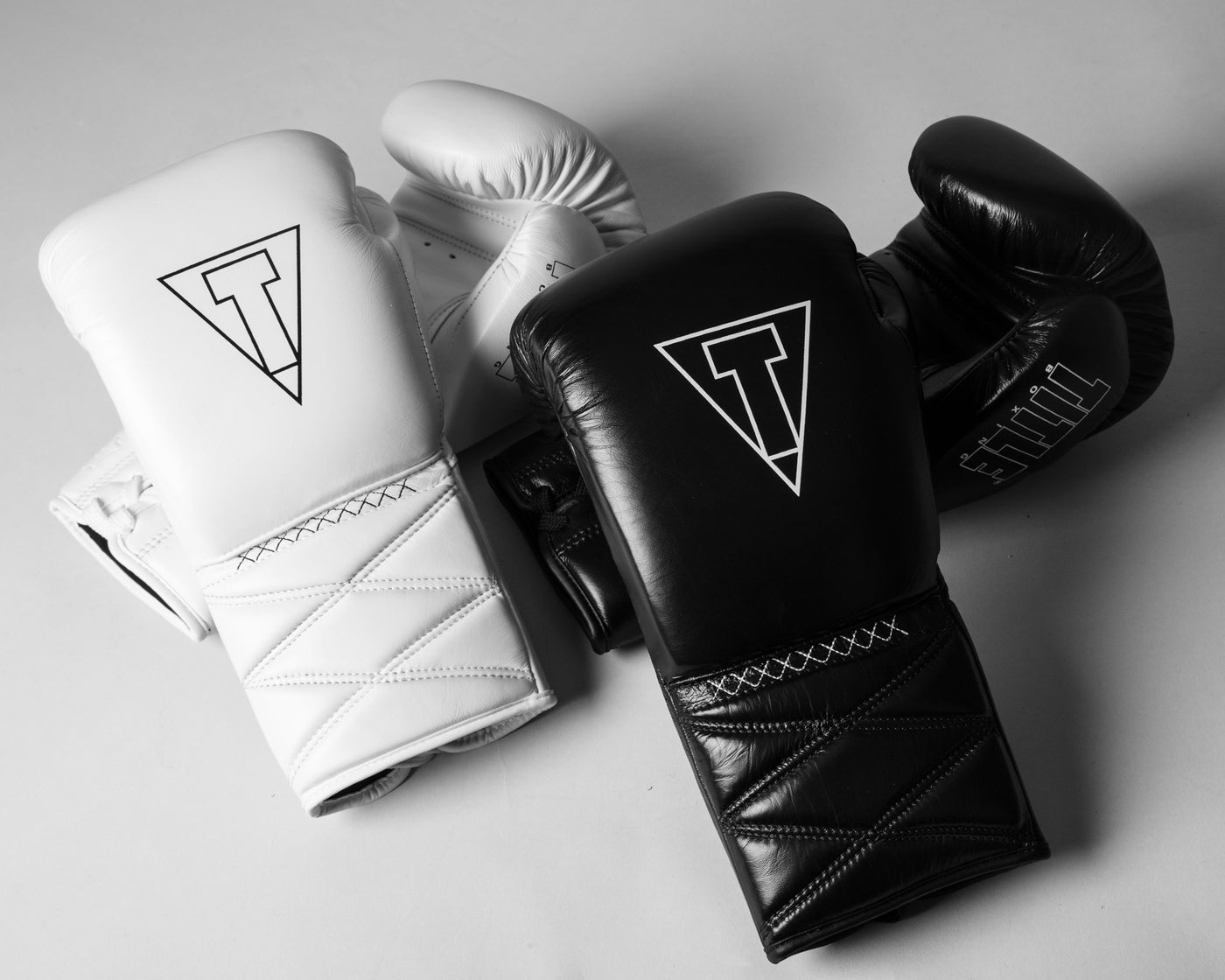 variant:black::TITLE Boxing Momentum Pro Sparring Gloves side by side with white pair