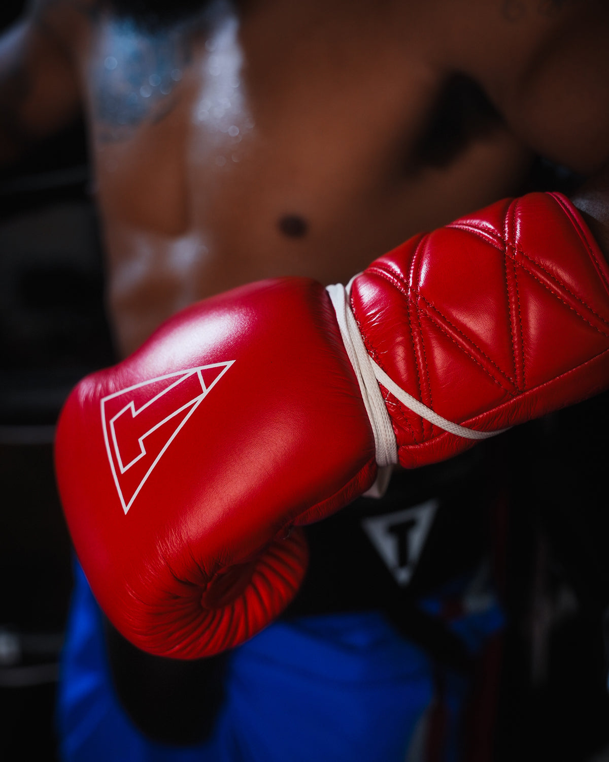 variant:red::TITLE Boxing Momentum Pro Sparring Gloves closeup on boxer's hand
