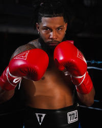 variant:red::TITLE Boxing Momentum Pro Sparring Gloves on boxer's hands fighting stance