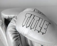 variant:silver/black::TITLE Boxing Momentum Pro Sparring Gloves closeup of logo