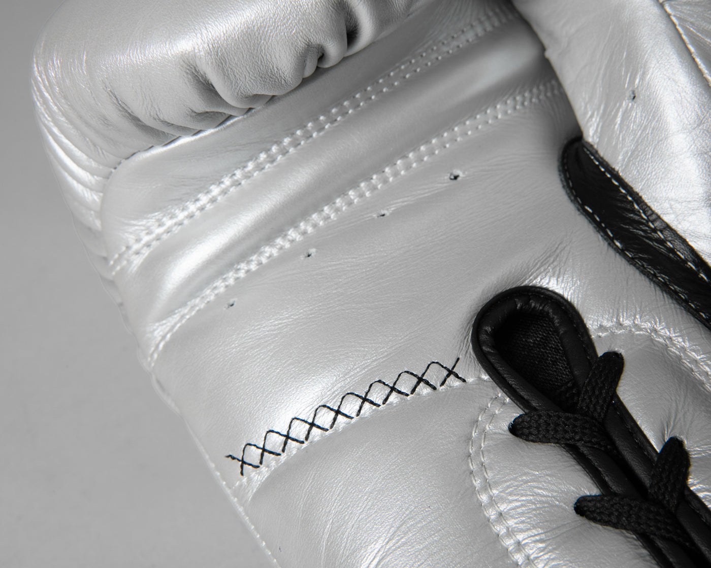 variant:silver/black::TITLE Boxing Momentum Pro Sparring Gloves closeup of stitching