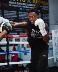 variant:white::TITLE Boxing Momentum Pro Sparring Gloves on boxer training with coach in the ring