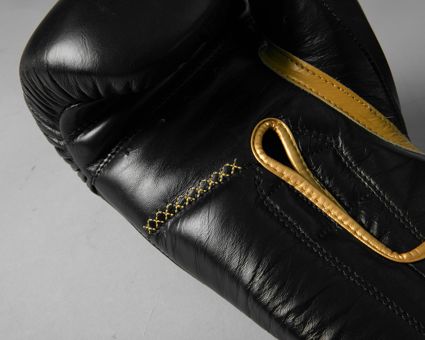variant:black/gold::TITLE Boxing Momentum Pro Training Gloves closeup of palm side