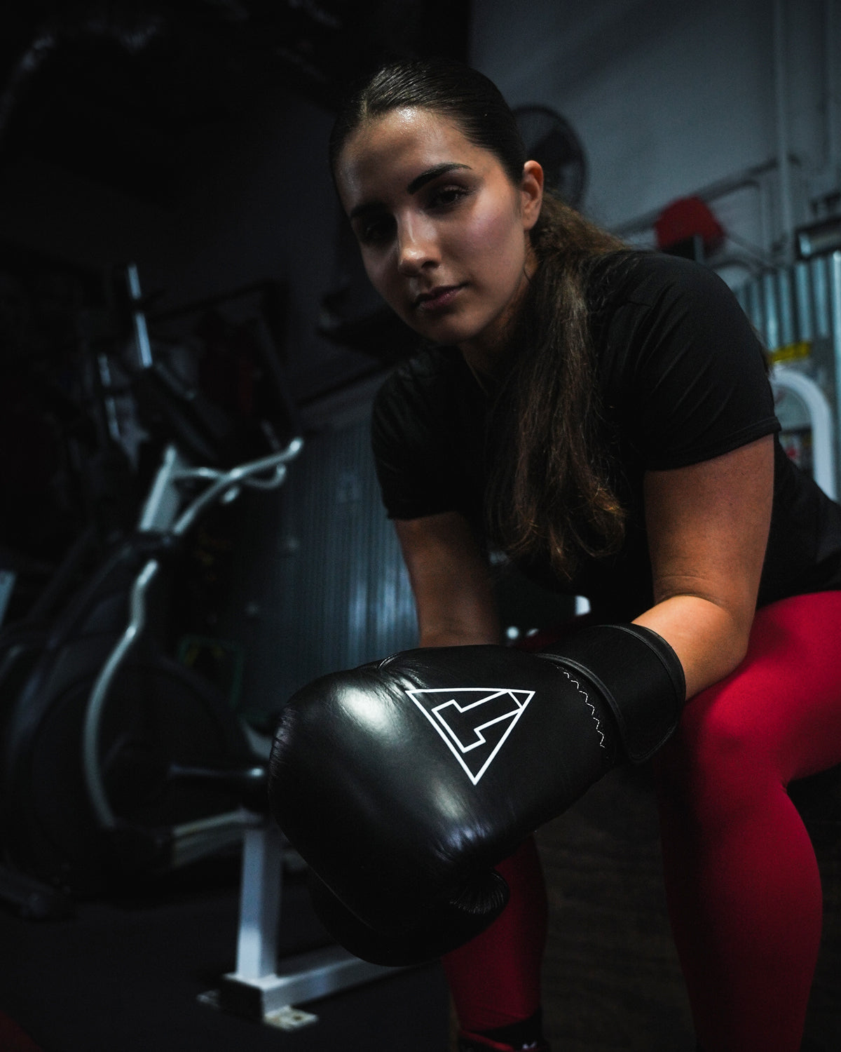 variant:black::TITLE Boxing Momentum Pro Training Gloves on boxer at the gym