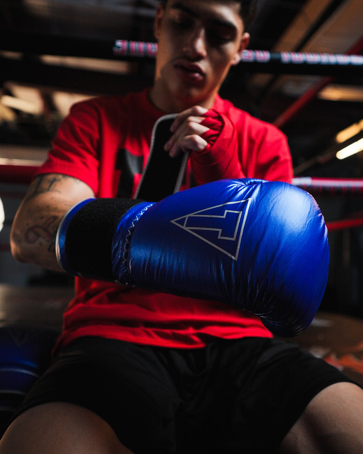 variant:blue/silver::TITLE Boxing Momentum Pro Training Gloves closeup of glove on boxer