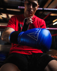 variant:blue/silver::TITLE Boxing Momentum Pro Training Gloves closeup of glove on boxer
