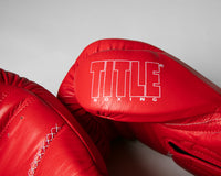 variant:red::TITLE Boxing Momentum Pro Training Gloves closeup of logo on thumb