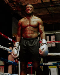 variant:Silver/Black::TITLE Boxing Momentum Pro Training Gloves boxer in the ring with gloves on