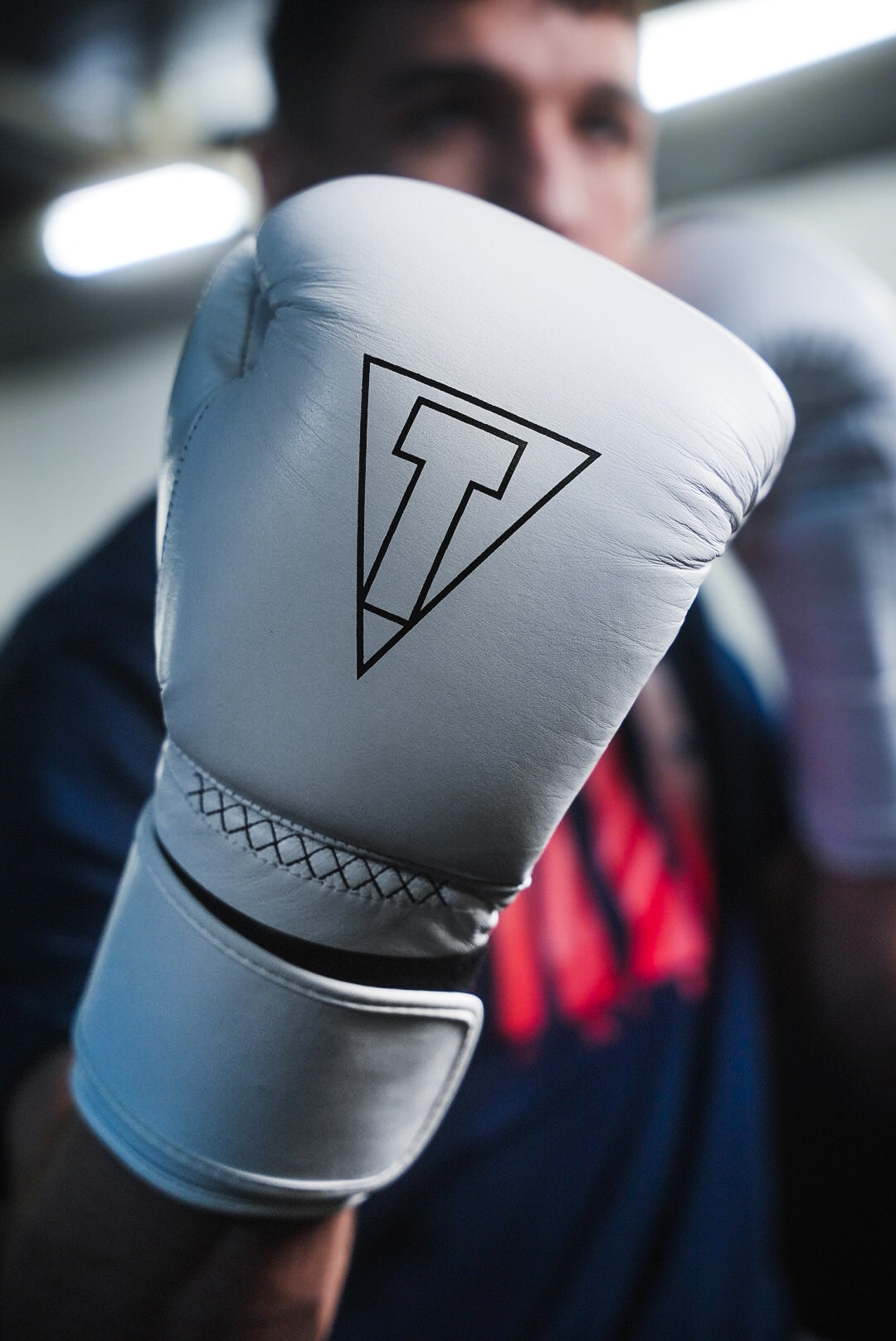 variant:white::TITLE Boxing Momentum Pro Training Gloves closeup of glove on boxer's hand