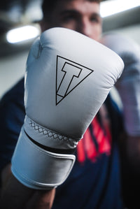 variant:white::TITLE Boxing Momentum Pro Training Gloves closeup of glove on boxer's hand